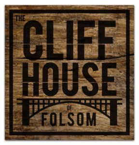 Cliff House logo with rustic wood background.